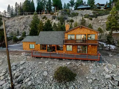 a wooden house on a hill with rocks at Big Blue Views Walk 2 Lake in Tahoe Vista