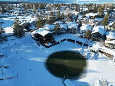 an aerial view of a town with snow covered roofs at Tahoe Waterfront Condo with Boat Dock in South Lake Tahoe