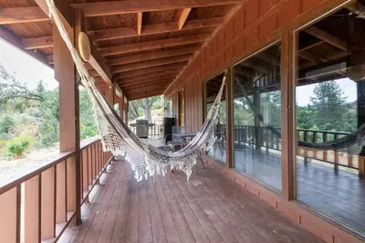 a hammock on the porch of a house at The Badger House in Badger