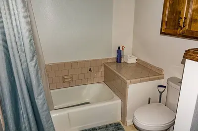 a bathroom with a bath tub and a toilet at The Badger House in Badger