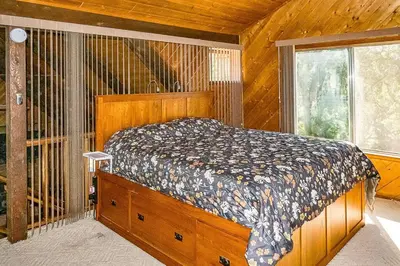 a bedroom with a bed in a room with a window at The Badger House in Badger