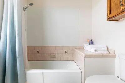 a bathroom with a tub and a toilet and a sink at The Badger House in Badger