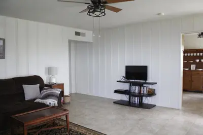 a living room with a couch and a flat screen tv at Hummingbird Hill - Entire Cabin in Dunlap