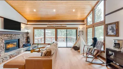 a living room with a couch and a fireplace at In Northstar Ski Resort Game Room Family-Friendly Dakine Haus by AvantStay in Truckee