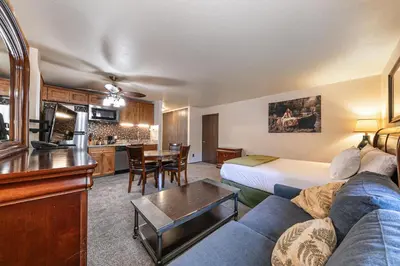 a hotel room with a couch and a table at Cozy Studio w/Kitchenette Easily Accessible #113 at Donner Lake Village in Truckee