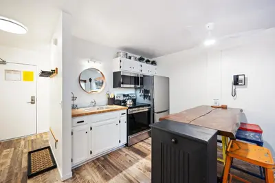 a kitchen with white cabinets and a counter top at Striking Queen Deluxe Studio w/Kitchenette #114 at Donner Lake Village in Truckee