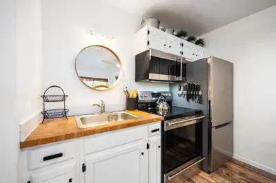 a kitchen with a sink and a stainless steel refrigerator at Striking Queen Deluxe Studio w/Kitchenette #114 at Donner Lake Village in Truckee