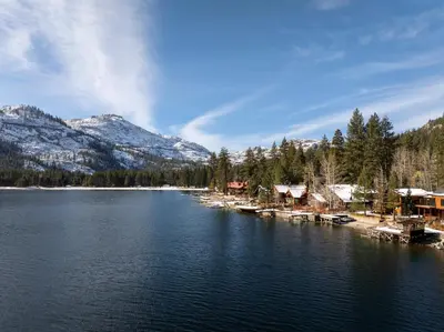 a view of a lake with mountains in the background at Striking Queen Deluxe Studio w/Kitchenette #114 at Donner Lake Village in Truckee