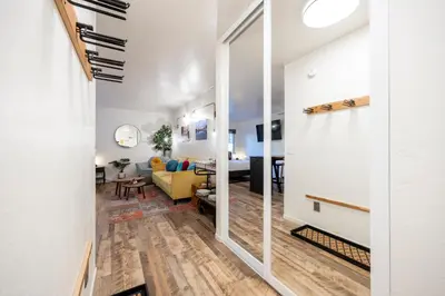 a living room with a yellow couch and a table at Striking Queen Deluxe Studio w/Kitchenette #114 at Donner Lake Village in Truckee