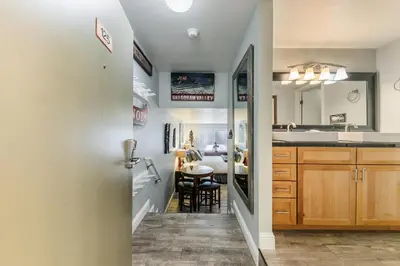 a kitchen with a sink and a dining room at Partial Lake View Stunning Deluxe King Studio #125 at Donner Lake Village in Truckee