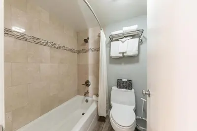 a bathroom with a tub and a toilet and a sink at Partial Lake View Stunning Deluxe King Studio #125 at Donner Lake Village in Truckee