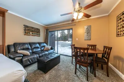 a living room with a couch and a dining room table at Cozy Deluxe Studio #131 at Donner Lake Village in Truckee