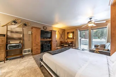 a bedroom with a bed and a large window at Cozy Studio 1st Floor #132 at Donner Lake Village in Truckee