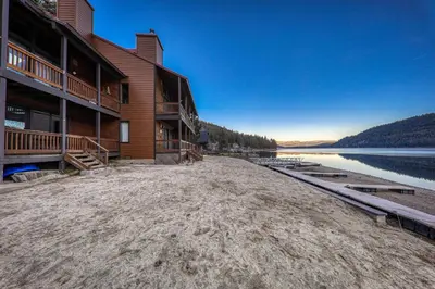 a large building on the shore of a lake at Cozy Studio 1st Floor #132 at Donner Lake Village in Truckee