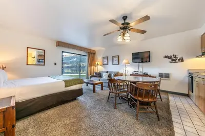 a hotel room with a bed and a table and a kitchen at Quiant Studio w/Lake View #144 at Donner Lake Village in Truckee