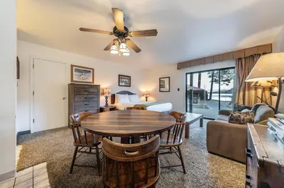 a living room with a table and a bedroom at Quiant Studio w/Lake View #144 at Donner Lake Village in Truckee