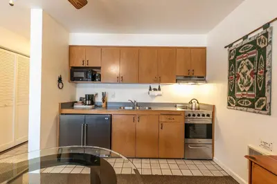a kitchen with wooden cabinets and stainless steel appliances at Cozy King Studio w/Lake View #145 at Donner Lake Village in Truckee