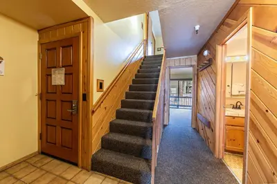 a hallway with a staircase in a house at Comfortable Townhouse w/Lake View #154 at Donner Lake Village in Truckee