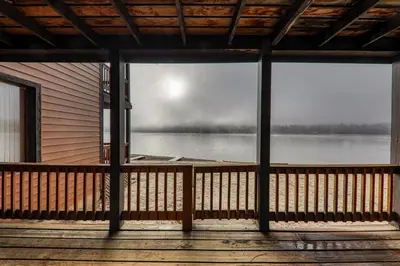 a view of a lake from the porch of a cabin at Comfortable Townhouse w/Lake View #154 at Donner Lake Village in Truckee