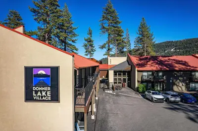 a town with a lake village sign on the side of a building at Modern Studio w/Balcony #211 at Donner Lake Village in Truckee