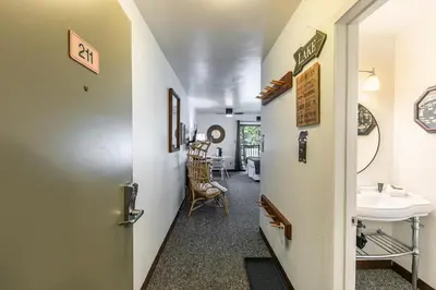 a hallway leading to a bathroom with a sink at Modern Studio w/Balcony #211 at Donner Lake Village in Truckee