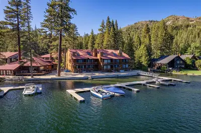 a house on a lake with boats in the water at Modern Studio w/Balcony #211 at Donner Lake Village in Truckee