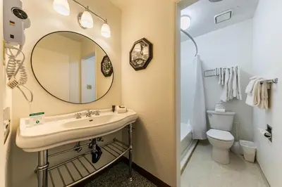 a bathroom with a sink and a mirror and a toilet at Modern Studio w/Balcony #211 at Donner Lake Village in Truckee