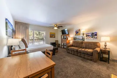 a living room with a bed and a couch at Cozy Studio w/Kitchenette and Balcony #212 at Donner Lake Village in Truckee