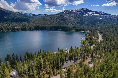 an aerial view of a lake with trees and mountains at King Deluxe Studio 2nd Floor Unit 216 Bldg B in Truckee