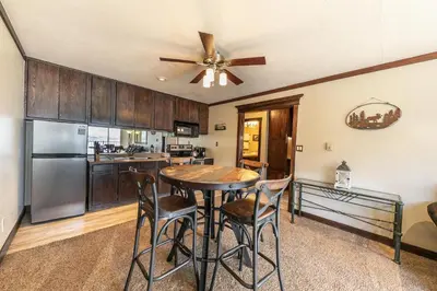 a kitchen with a table and chairs and a ceiling fan at Spacious Condo w/Lake View #247 at Donner Lake Village in Truckee
