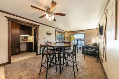 a kitchen and living room with a table and chairs at Spacious Condo w/Lake View #247 at Donner Lake Village in Truckee