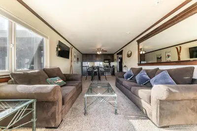 a living room with two couches and a table at Spacious Condo w/Lake View #247 at Donner Lake Village in Truckee