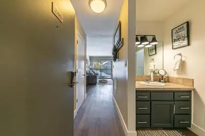a bathroom with a sink and a hallway at Charming Deluxe Studio w/Lake View #246 at Donner Lake Village in Truckee