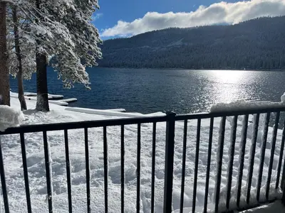 a fence next to a lake with snow on it at Beautiful Deluxe Studio w/Lake View #245 at Donner Lake Village in Truckee