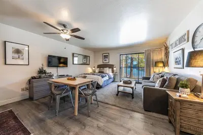a bedroom and living room with a bed and a couch at Beautiful Deluxe Studio w/Lake View #245 at Donner Lake Village in Truckee
