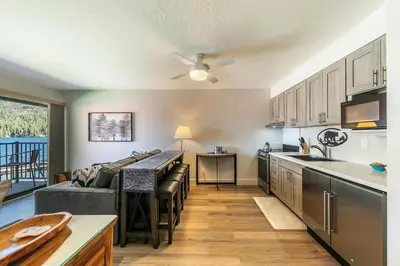 a kitchen and living room with a couch and a table at Striking Studio w/Lake View #244 at Donner Lake Village in Truckee