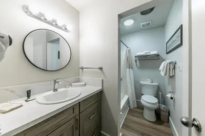 a bathroom with a sink and a mirror and a toilet at Striking Studio w/Lake View #244 at Donner Lake Village in Truckee