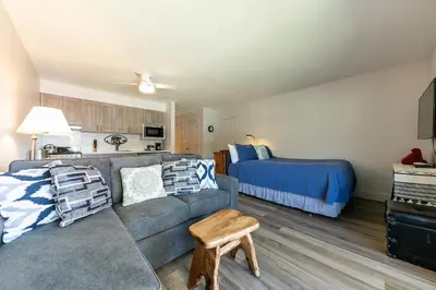 a living room with a couch and a bed at Striking Studio w/Lake View #244 at Donner Lake Village in Truckee