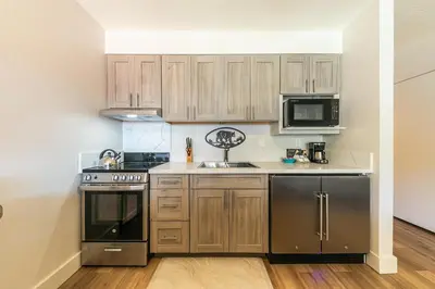 a kitchen with wooden cabinets and stainless steel appliances at Striking Studio w/Lake View #244 at Donner Lake Village in Truckee