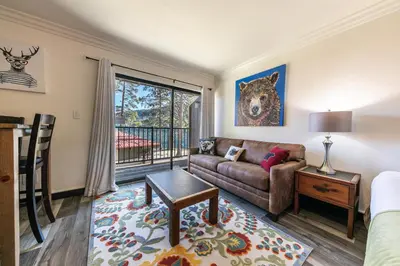 a living room with a couch and a window at Striking King Studio w/Partial Lake View #242 at Donner Lake Village in Truckee