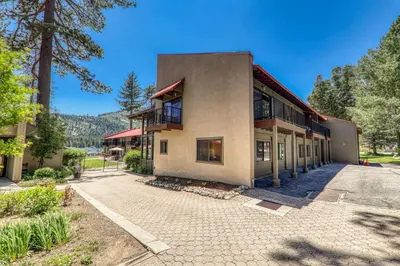 an exterior view of a building with trees at Striking King Studio w/Partial Lake View #242 at Donner Lake Village in Truckee