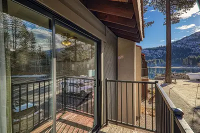 a balcony with a view of a lake and mountains at King Studio 2nd Floor #234 at Donner Lake Village in Truckee