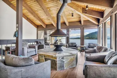 a living room with couches and a large fireplace at Charming Queen Studio Deluxe w/Balcony #233 at Donner Lake Village in Truckee