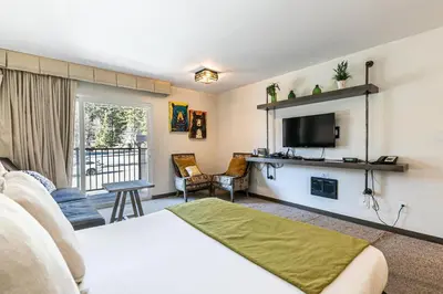 a living room with a bed and a tv at Modern Studio Deluxe #231 at Donner Lake Village in Truckee