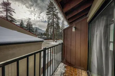 a balcony of a house with snow on the ground at Cozy Studio #226 at Donner Lake Village in Truckee