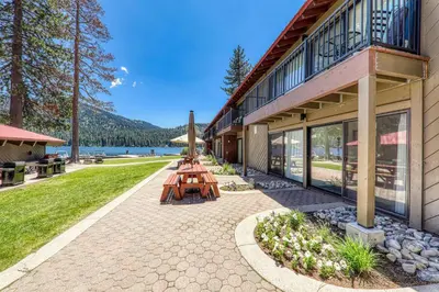 a group of picnic tables outside of a building at Cozy Studio #226 at Donner Lake Village in Truckee