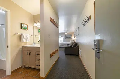 a hallway with a bathroom with a sink and a toilet at Cozy Studio wKitchen #217 at Donner Lake Village in Truckee