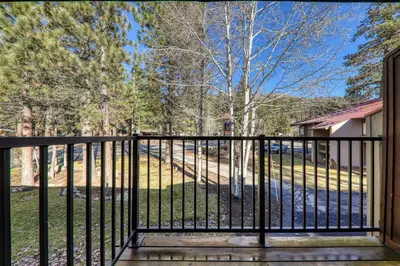 a balcony with a black fence and trees at Studio w/Kitchen 2nd Floor #213 at Donner Lake Village in Truckee