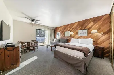 a hotel room with a bed and a dining room at Homey 1st Floor Studio #135 at Donner Lake Village in Truckee