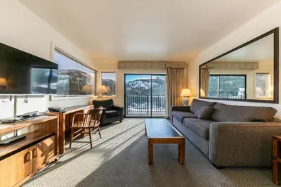 a living room with a couch and a tv at Spacious 1BR Condo w/ Lake View #136 at Donner Lake Village in Truckee
